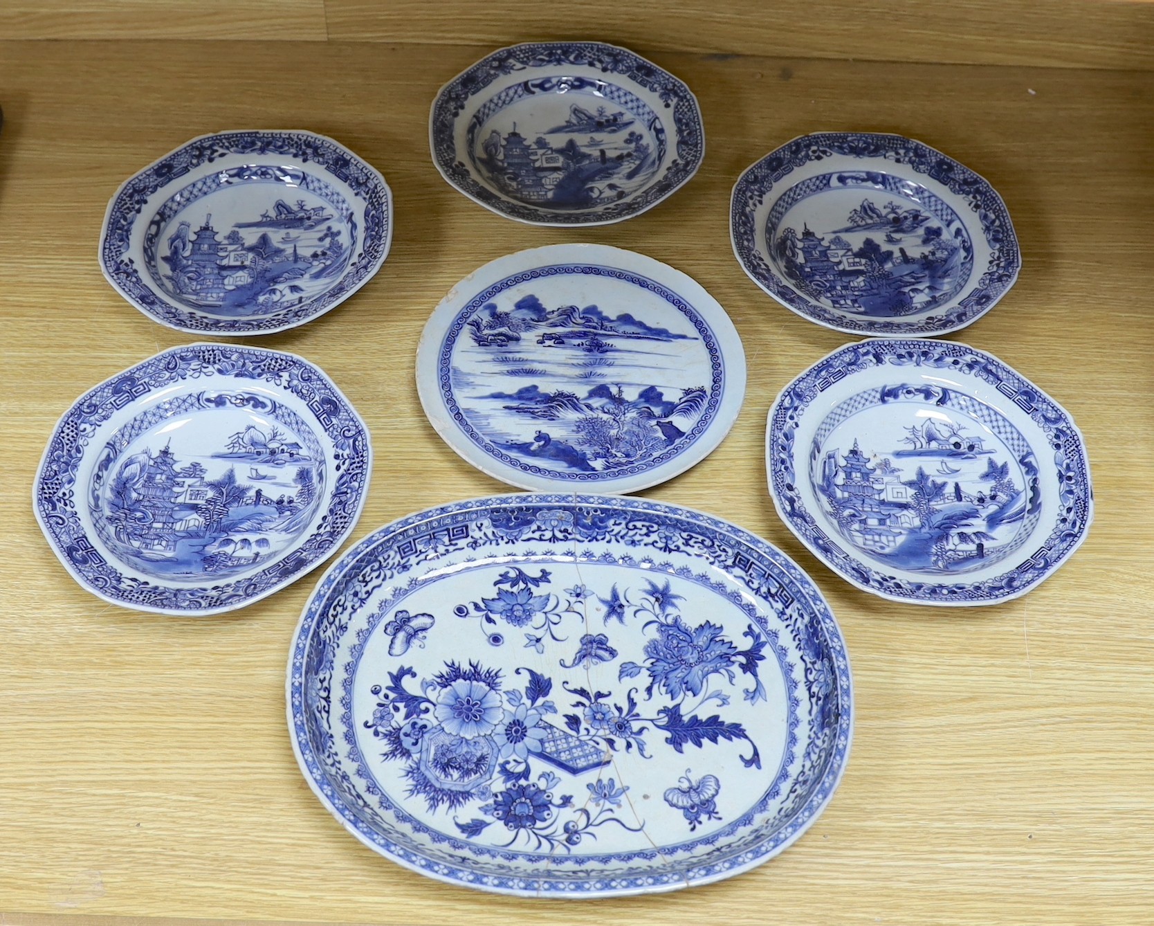 A selection of severn 18th century Chinese export blue and white dishes, largest 35cm wide